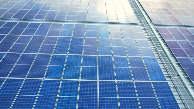 4K : Aerial View above Solar Photovoltaic Modules on Rooftop of Shopping Mall, Alternative Energy Source. drone footage. Nonthaburi, Thailand

