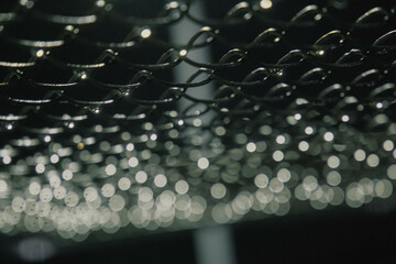 metal mesh in the rays of sunlight, sun glare