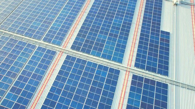 4K : Aerial view of the solar panels on the roof of a shopping mall building in Nonthaburi, Thailand. producing clean ecological electricity
