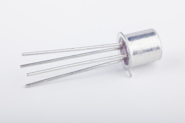 Old metal transistor BFY90 M8727 on white background. Electronic component. Vintage semiconductor device. 