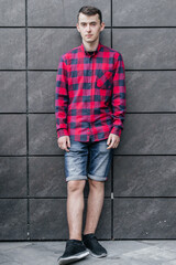 young handsome guy in a red checkered shirt