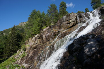Fototapeta na wymiar Czarnostawianska Siklawa – cascading waterfall in the Polish High Tatras. Tatra National Park, Poland.