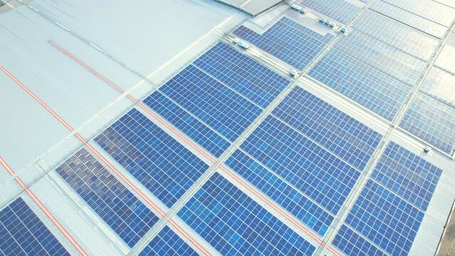 Top view of a solar power station on building roof, Renewable green energy. Clean energy industry in Nonthaburi, Thailand. drone footage. 4k
