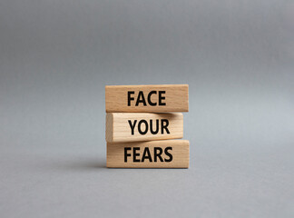 Face your Fears symbol. Wooden blocks with words Face your Fears. Beautiful grey background. Business and Face your Fears. Copy space.