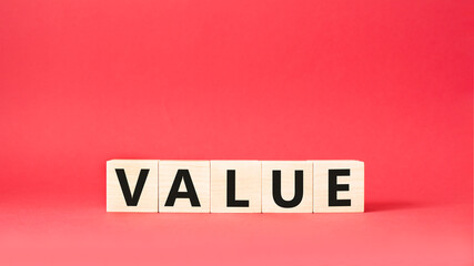 Value symbol. Concept word value on wooden cubes. Beautiful red background. Business and value concept. Copy space.