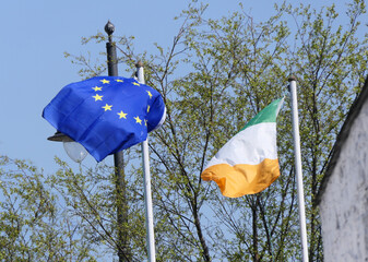 EU and Irish National Flag flying in garden Ireland