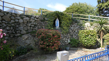 Statue of Virgin Mary Lourdes France Basilica grotto in Carlingford Village and Lough County Louth on Irish Sea - obrazy, fototapety, plakaty