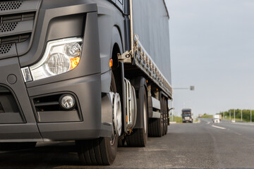 The concept of cargo transportation. Trucker's Day. A black truck is parked on the side of the...
