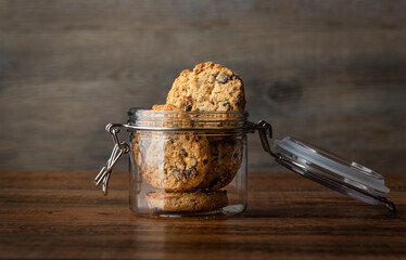 Glass cookie jar with oat and raisin homemade cookies