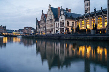 Fototapeta na wymiar Houses reflected on the water of the canal in Ghent