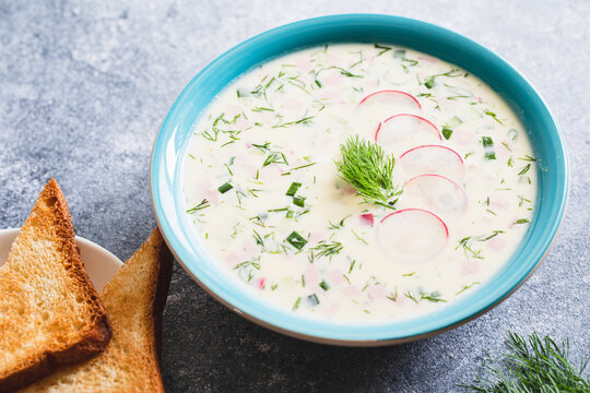 Summer yoghurt cold soup with radish, cucumber, potato and and sausage. Okroshka. Summer cold soup.