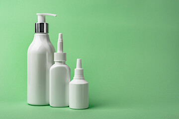 White cosmetic tubes on mint color background with copy space. Skin care, body care, beauty concept. Banner.