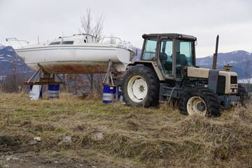 old tractor in the mountains with boat behind in the alps france