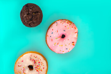donuts and a cupcake on a turquoise background 