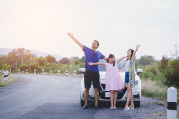 Concept of happy family travel by car. Freedom family with father,mother and daughter having fun on...