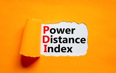PDI power distance index symbol. Concept words PDI power distance index on white paper on a beautiful orange background. Business PDI power distance index concept. Copy space.