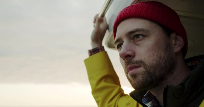 portrait of a sailor in a yellow raincoat sailing on a ship