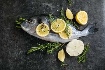Raw dorado fish with spices. Dorado and ingredients for cooking on a table