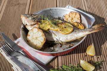 Delicious Grilled dorado fish with lemon and parsley. Whole Bbq sea bream baked. Dorado grill. Ketogenic, keto or paleo diet lunch, Healthy food trend. Top view,