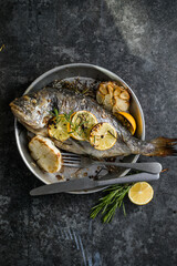 Delicious Grilled dorado fish with lemon and parsley. Whole Bbq sea bream baked. Dorado grill....