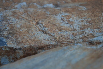 Rough texture of fine natural stone, photographed during golden hour, selective focus