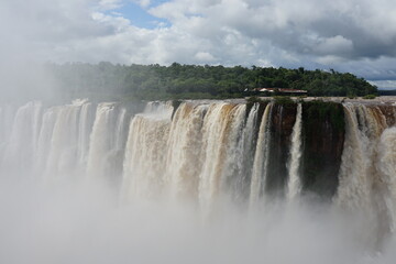 The photo shows a stunning view from the top of the Iguazu Falls — a complex of 275 waterfalls on the Iguazu River, located on the border of Brazil and Argentina