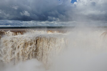 The photo shows a stunning view from the top of the Iguazu Falls — a complex of 275 waterfalls on the Iguazu River, located on the border of Brazil and Argentina