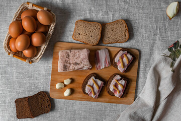 rustic natural food, on a linen tablecloth a wooden board, on it are ready-made sandwiches from...