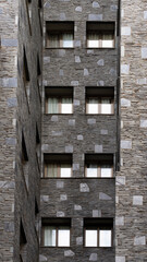 Tall gray stone brick building, set of geometric shapes