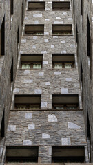 Tall gray stone brick building, set of geometric shapes