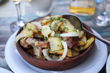 Georgian national dish ojahuri with meat on wooden background