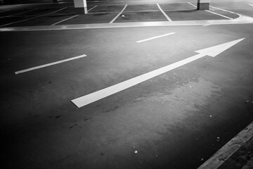 shot of greyscale  parking garage without cars