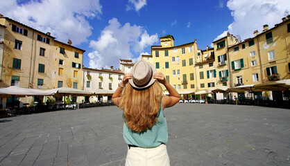 Travel in Italy. Panoramic banner view of young tourist woman visiting the historic city of Lucca in Tuscany, Italy. - obrazy, fototapety, plakaty