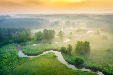 Aerial view of natural river during foggy morning