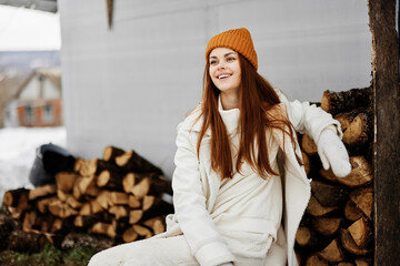 portrait of a woman chopping firewood in nature in winter for heating Lifestyle