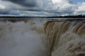 The photo shows a stunning view from the top of the Iguazu Falls — a complex of 275 waterfalls on the Iguazu River, located on the border of Brazil and Argentina