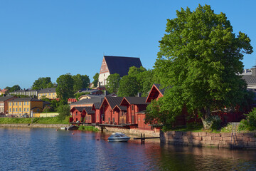 Obraz premium Panorama of old Finnish city of Porvoo: summer, sunny day, river, bridge, old wooden houses, medieval church.