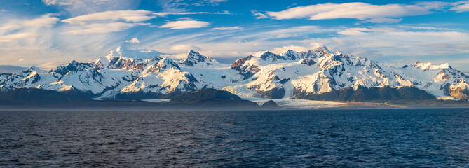 Late evening sun on panorama of mountains and Mount Fairweather by Glacier Bay National Park in...