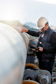 Technician are testing to welds of pipe with ultrasonic test method. It is a family of non-destructive testing techniques based on the propagation of ultrasonic waves in the object or material tested.