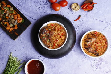 Fried rice with chicken prepared and served in a wok natural wood in the background top view
