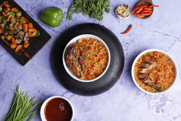 Fried rice with chicken prepared and served in a wok natural wood in the background top view