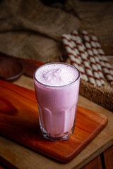 Coffee cups milk beans and ground coffee in jar on wooden background high quality photo