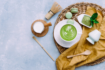 Green tea latte in white cup next to matcha powder. Japanese tea ceremony concept. Detox tea....
