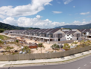 Fototapeta na wymiar SEREMBAN, MALAYSIA -MARCH 4, 2021: Selected focused on double story terrace house under construction in Malaysia. Designed by an architect with a modern and suite with tropical climate. 