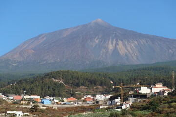 Fototapeta na wymiar Icod de los Vinos, Tenerife, Spain, June 10, 2022: Mount Teide volcano, 3,715 m, seen from Icod de los Vinos, Tenerife, Spain