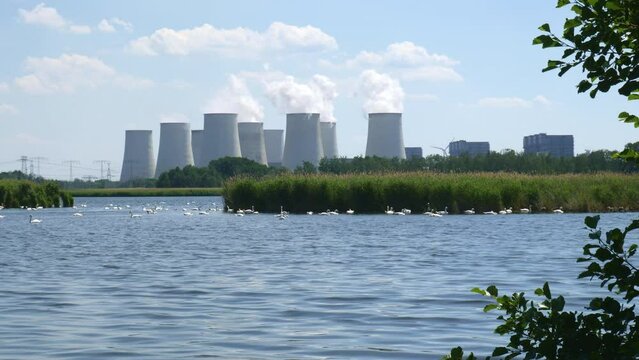 Coal power station J&auml;nschwalde behind lake with swans  
