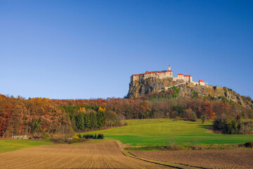Fototapeta na wymiar The medieval Riegersburg Castle on top of a dormant volcano, surrounded by beautiful autumn landscape, famous tourist attraction in Styria region, Austria