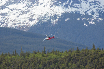 Fototapeta na wymiar Helicopter on final descent in Alaskan mountain range