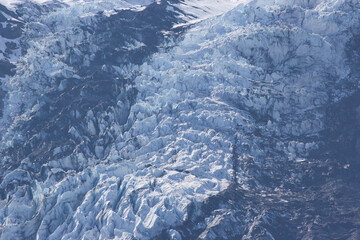 Large valley of ice leading up into the mountains from the water