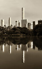 Iconic New York skyscrapers reflected in Central Park's lake in Black and White. 